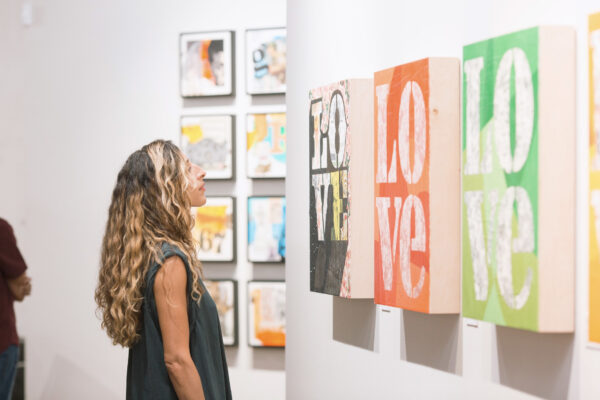 Photo of a visitor looking at a work of art on a wall